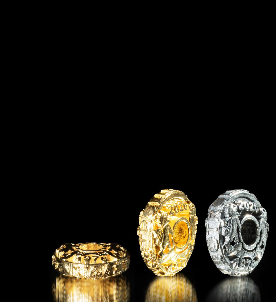 Silver and gold-plated jubilee coins on black background