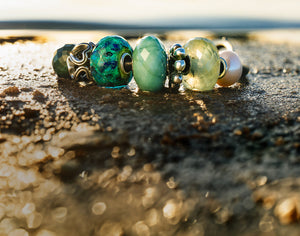 Trollbeads leather bracelet with green hues in gemstone, glass and silver beads 